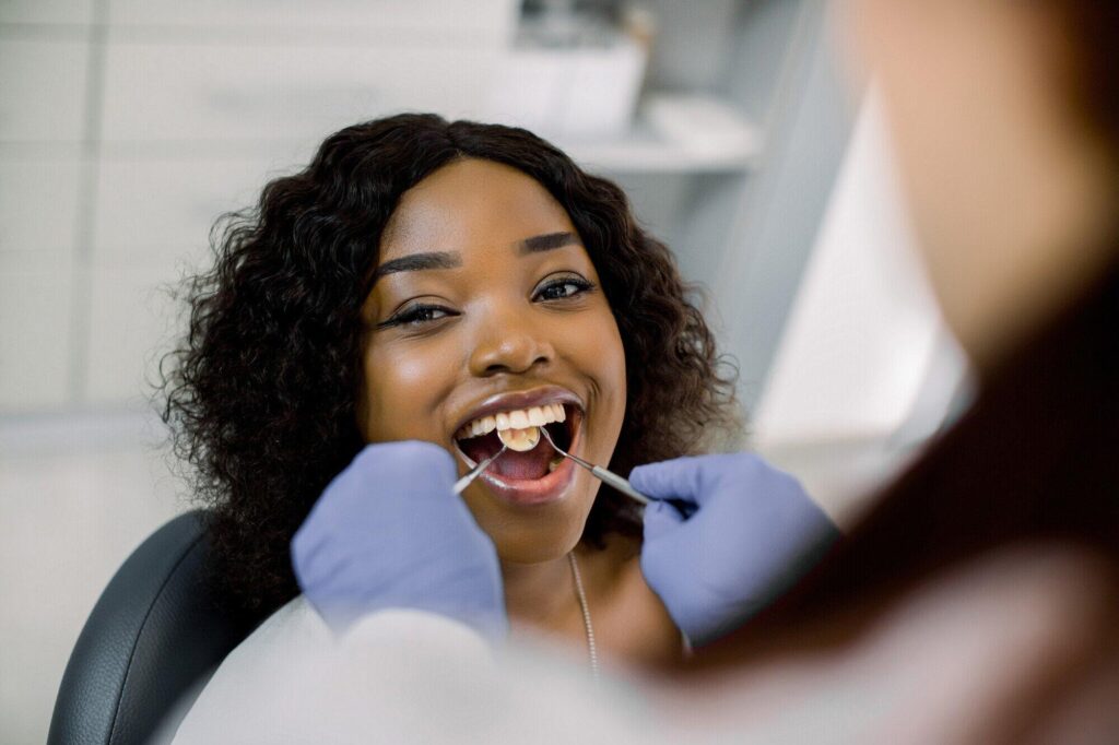 Dental professional examining a patient in a clinic setting
